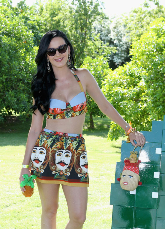 Katy Perry carrying a straw Carmen Miranda bag by Lulu Guinness (complete with cherry earrings and pineapple hat).